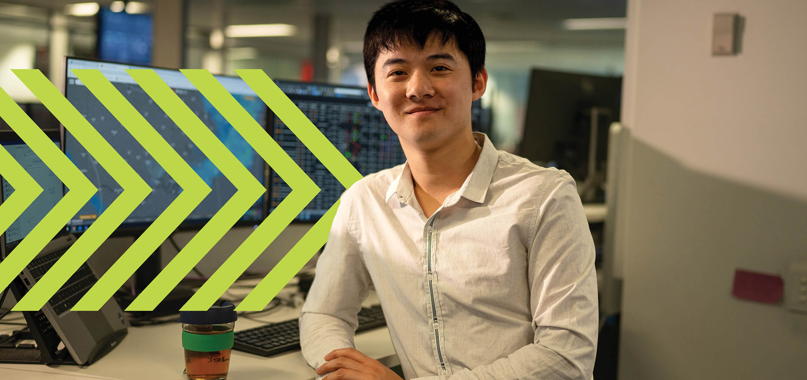 A smiling man sitting at an office desk
